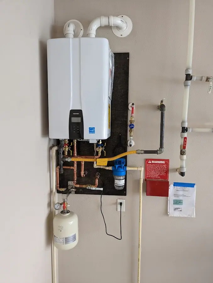 Professional plumber installing copper piping in a North Berwick home